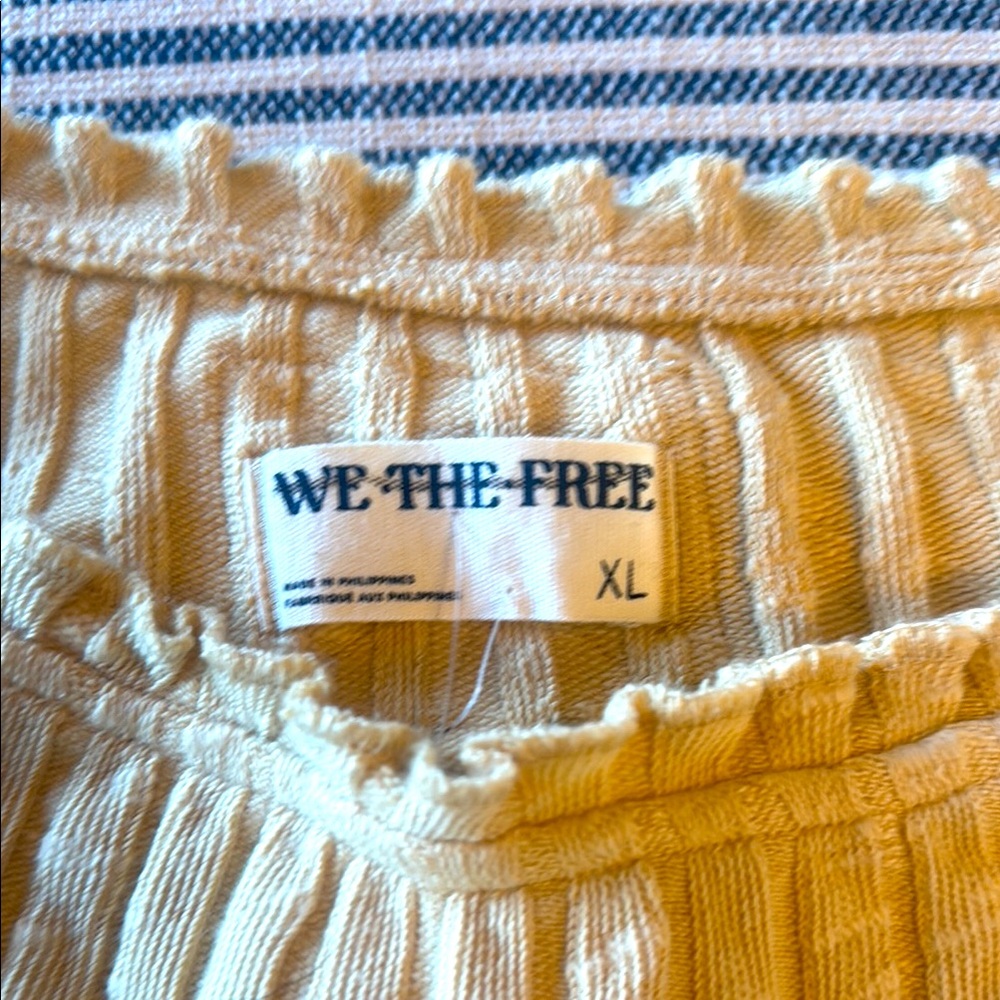 We The Free Textured yellowish in color, brand new.